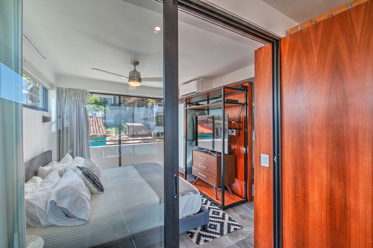 Bedroom viewed from the balcony through a sliding door