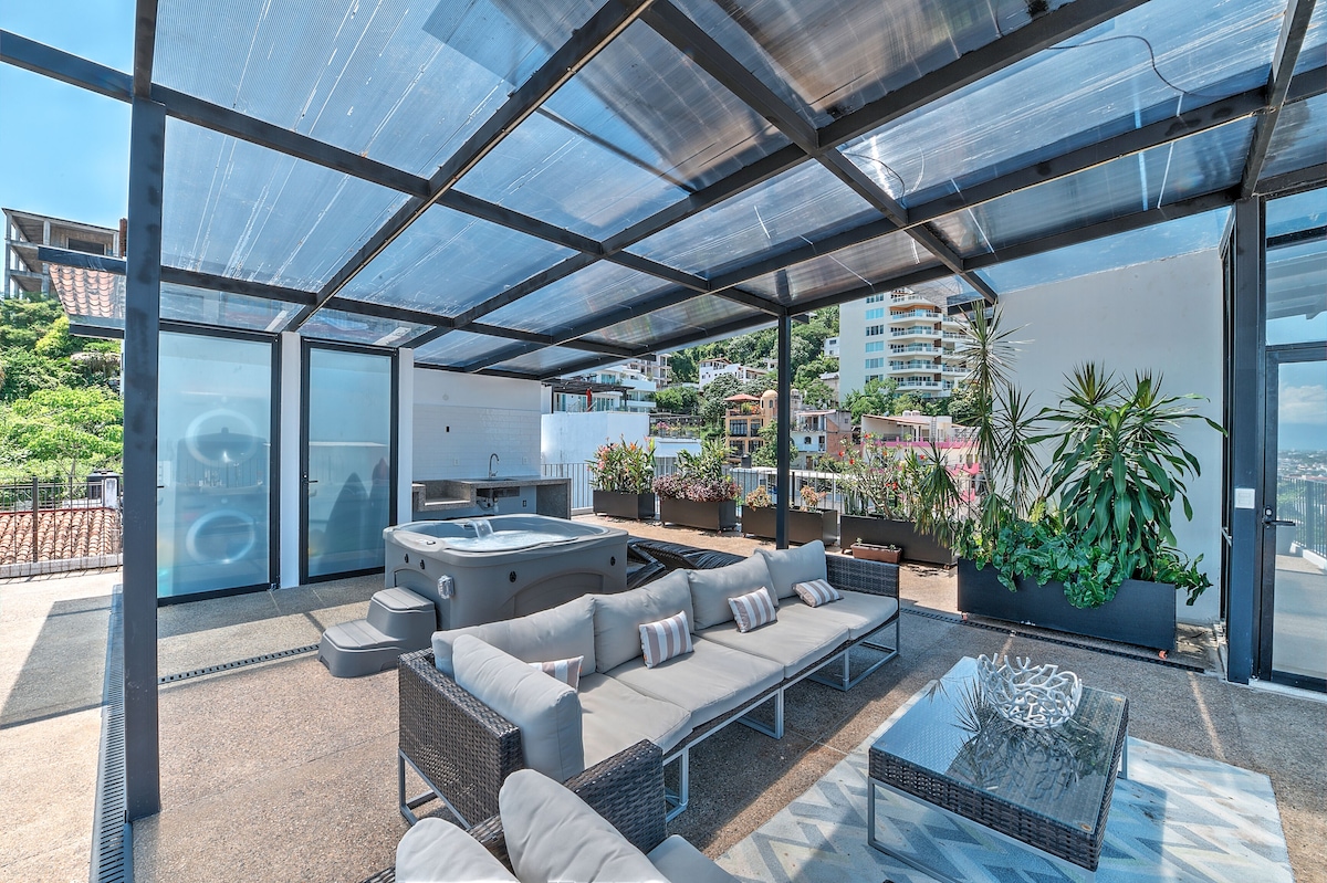 Private rooftop terrace with a hot tub and outdoor sofas